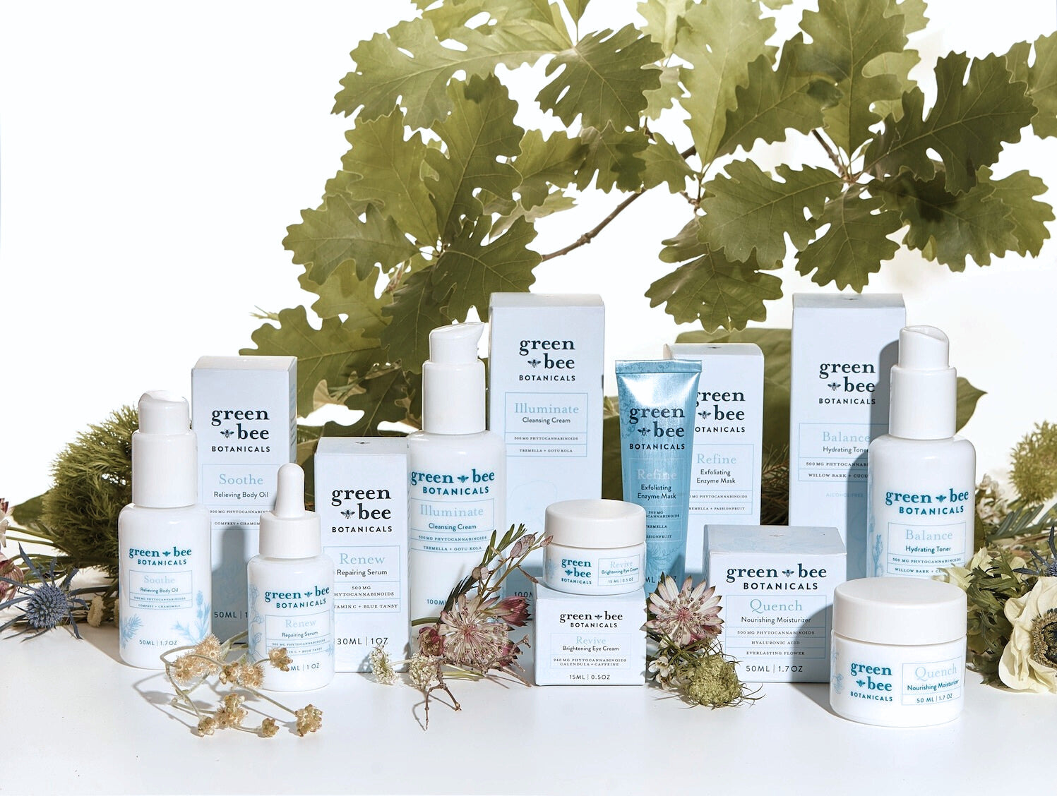 Photo of Green Bee Botanicals Spa Collection Skin Care and Body Care products styled with flowers and greens